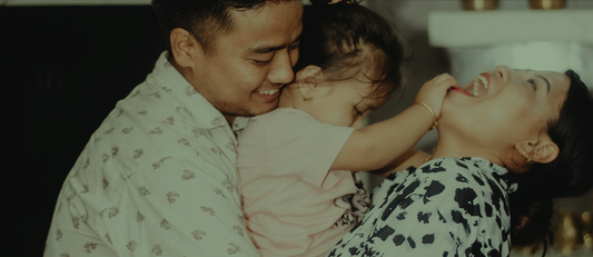 Happy smiling family of three; mom, dad anc child