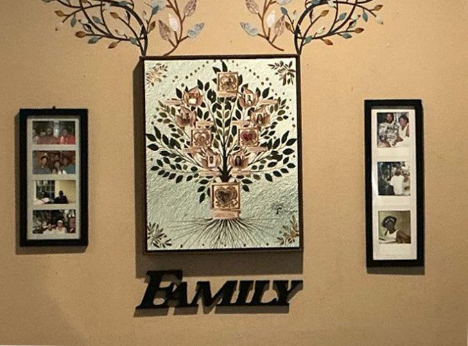 Love Tree Family Canvas displayed between two family photo frames above a Family sign